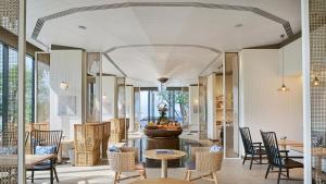 a lobby with chairs and a table in a building at Melia Koh Samui in Choeng Mon Beach