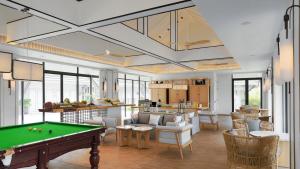 a living room with a pool table in it at Melia Koh Samui in Choeng Mon Beach