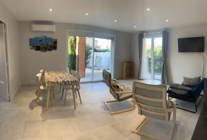 a living room with a table and chairs at Boost Your Immo Six Fours Les Plages le Mistral 252 in Six-Fours-les-Plages