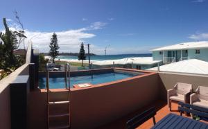 a swimming pool on top of a house at Beach House Mollymook in Mollymook