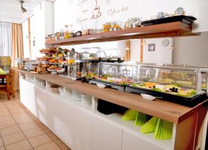 a buffet line in a restaurant with food at Hotel Herrenhof in Lübeck