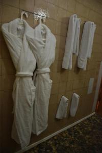 a group of white towels hanging on a wall at Ekaterininsky Gostinichny Kompleks in Krasnodar