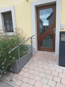 a door to a house with a plant next to it at fewoflagmeier Kohlstetten I Alte Backstube in Kohlstetten