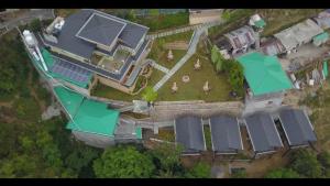 an aerial view of a house with solar panels on it at Larisa Resort, Mussoorie in Mussoorie