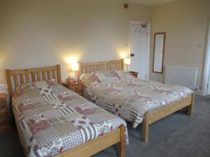 Postel nebo postele na pokoji v ubytování Acorn Guest House
