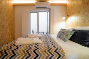 a bedroom with a bed with two towels on it at Friendly Border City Design Apartments in Lisbon