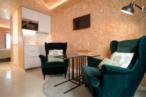 a living room with two chairs and a table at Friendly Border City Design Apartments in Lisbon