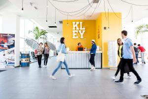 a group of people walking around a store lobby at Résidence Kley Toulouse in Toulouse +1 photo