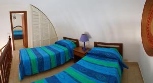 a bedroom with two beds and a mirror at Maridea - Salina in Ponza