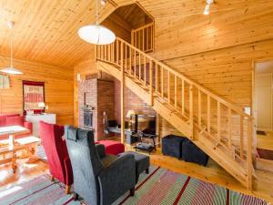 a living room with a staircase in a house at Holiday Home Käränkämökki by Interhome in Kolinkylä