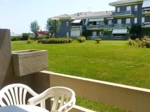 a table and chairs on a balcony with a lawn at Studio Green Marine- Palme- Ismare-11 by Interhome in Silvi Marina +3 photos