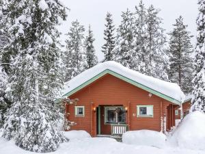 a red cabin with snow on the roof at Holiday Home Lomamaja 3 by Interhome in Raattama