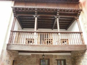 a balcony of a building with chairs on it at El Nozalon Picos de Europa in Poo de Cabrales