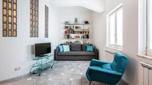 ein Wohnzimmer mit einem Sofa und einem TV in der Unterkunft San Domenico Apartment in Taormina