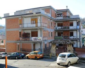 a building with cars parked in front of it at Magic Rainbow in Segni