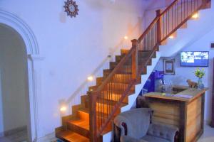 a room with a staircase with a chair and a table at Green Heritage Holiday Resort in Mahiyangana