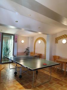 a ping pong table in the middle of a room at La Côte Bleue in Bouzigues
