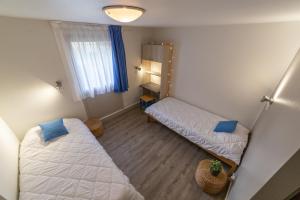 a small room with two beds and a window at VVF Normandie Veules-les-Roses in Veules-les-Roses +38 photos