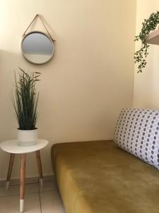 a room with a couch and a mirror and a table at Irini Apartments in Kavála