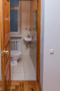 a bathroom with a toilet and a sink at KaunasInn - AM in Kaunas +30 photos