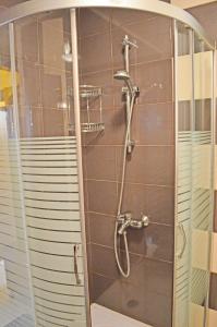 a shower with a glass door in a bathroom at Akra Apartments in Chernomorets +60 photos
