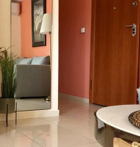 a living room with a couch and a mirror at Irini Apartments in Kavála