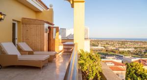 a hotel room with a balcony overlooking the ocean at Palm Oasis Maspalomas in Maspalomas