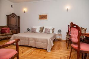 a bedroom with a bed and a table and chairs at KaunasInn - AM in Kaunas