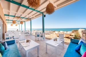 a restaurant with tables and chairs on the beach at Westpoint Dakhla in Dakhla