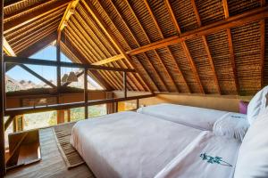 a bedroom with two beds in a room with a roof at Westpoint Dakhla in Dakhla