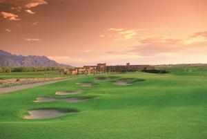 a view of a golf course with a resort in the background at Hyatt Regency Tamaya South Santa Fe in Santa Ana Pueblo