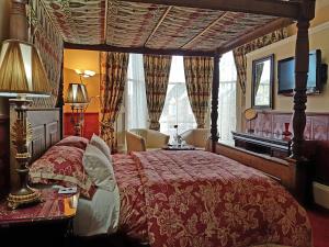 a bedroom with a large bed with a red bedspread at Lauderville guest house in Edinburgh