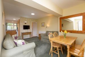 a living room with a couch and a table at Del Mar Court in St Martin Guernsey