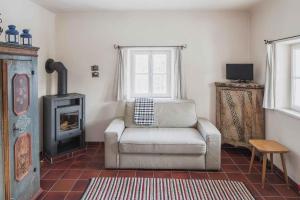 a living room with a chair and a stove at 2 Chalets Innsbruck in Innsbruck
