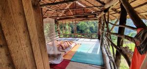 an inside view of a bamboo house with a pool at LOVELY JUNGLE LODGE & JUNGLE TREKING only book with us in Bukit Lawang