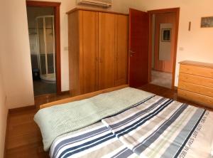 a bedroom with a bed and a dresser in it at Todor Seaside Apartments in Lovrečica