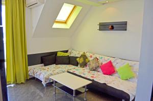 a living room with a couch and a table at Akra Apartments in Chernomorets