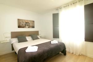 um quarto com uma cama com duas toalhas em MIQUEL ANGEL - Apartments with community terrace em Barcelona