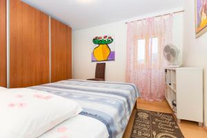 a small bedroom with a bed and a window at Crni in Drenje