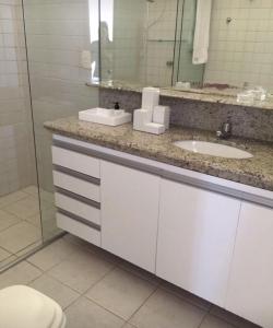 a bathroom with a sink and a mirror at Casa na praia em condomínio de luxo - Porto Brasil Resort in Parnamirim