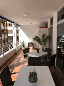 a room with tables and chairs in a building at Pauval Sunset in Puerto Naos +44 photos