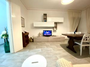 a living room with a dining table and a tv at Casa di Chiara in Polignano a Mare