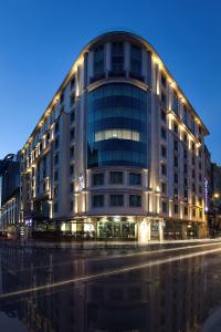
a large building with a clock on the front of it at Radisson Blu Hotel, Istanbul Sisli in Istanbul
