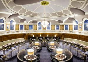 a banquet hall with tables and chairs and a chandelier at Hotel Indigo - Durham, an IHG Hotel in Durham