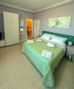 a large bedroom with a large green bed in it at B&B Planizie in Corridonia