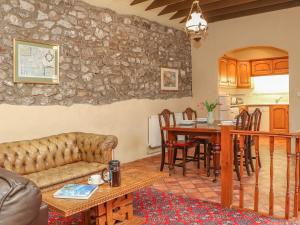 a living room with a couch and a table at Stoney Cottage in Narberth