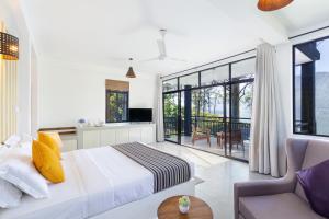 a bedroom with a bed and a couch and a window at The Farm Resorts in Hatton