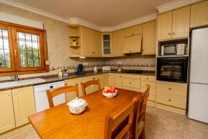 a kitchen with a wooden table with a bowl of fruit on it at Carpe Diem in Jávea