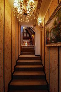 eine Treppe in einem Gebäude mit einem Kronleuchter in der Unterkunft Hotel The Stamp in ’s-Hertogenbosch