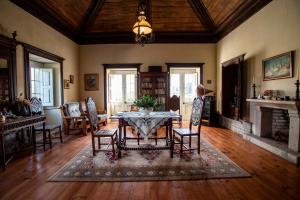 a living room with a table and chairs and a fireplace at Casa da Várzea in Beiral do Lima